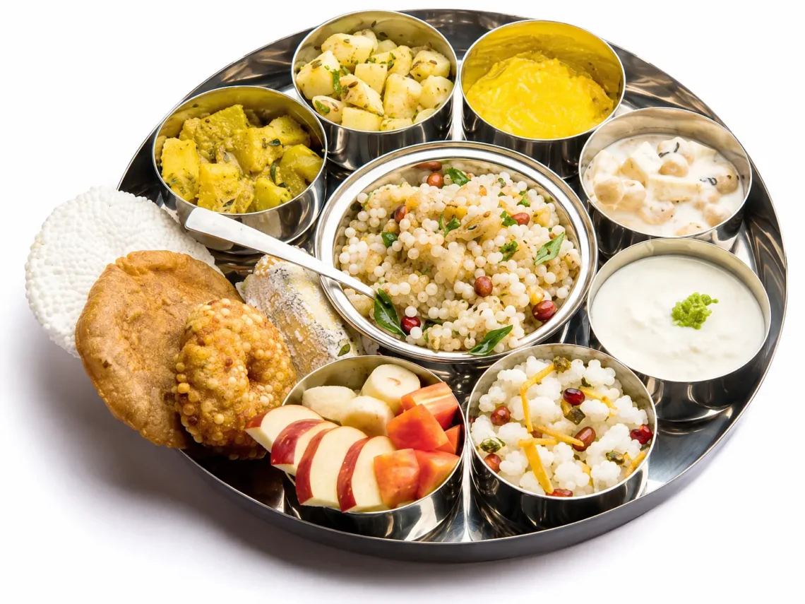 alt="Gujarati Farali Thali for Shravan featuring Sabudana Khichdi, Sabudana Vada, Rajgira Puri, Kheer, and fresh fruit slices"